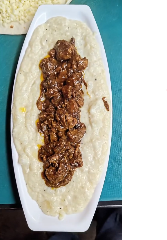 Creamy mashed potatoes topped with buff at QnQ Cafe Sainikpuri