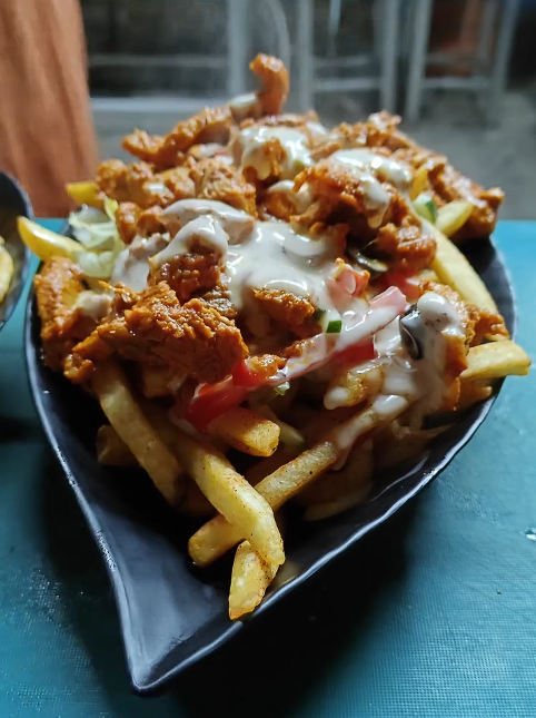 Dig A Chick — loaded fries topped with fried chicken and sauce at QnQ Cafe Sainikpuri
