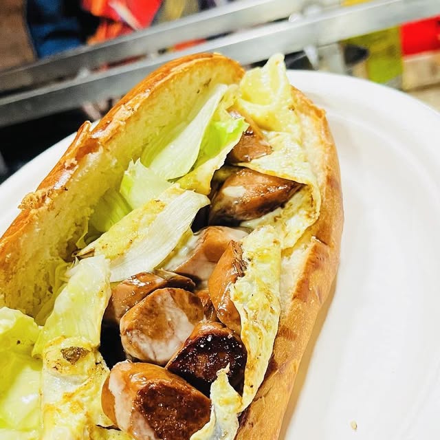 My Eggs Your Sausage — loaded chicken-sausage hotdog at QnQ Cafe Sainikpuri, Hyderabad